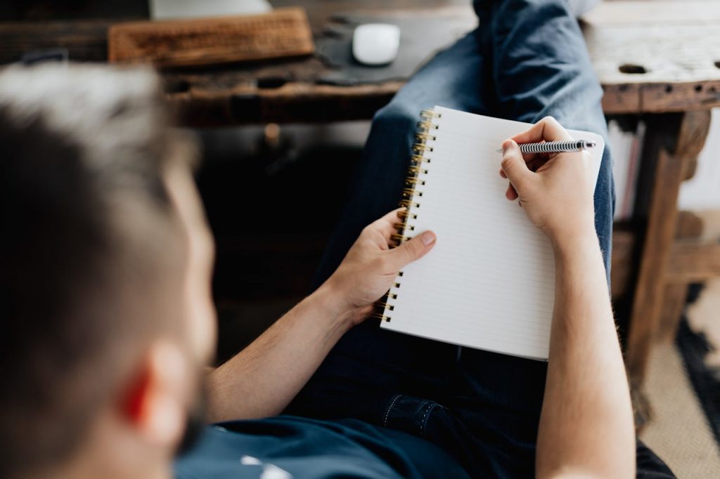 person holding orange pen