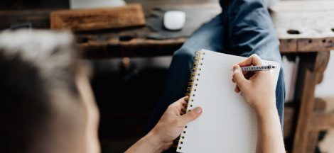 person holding orange pen